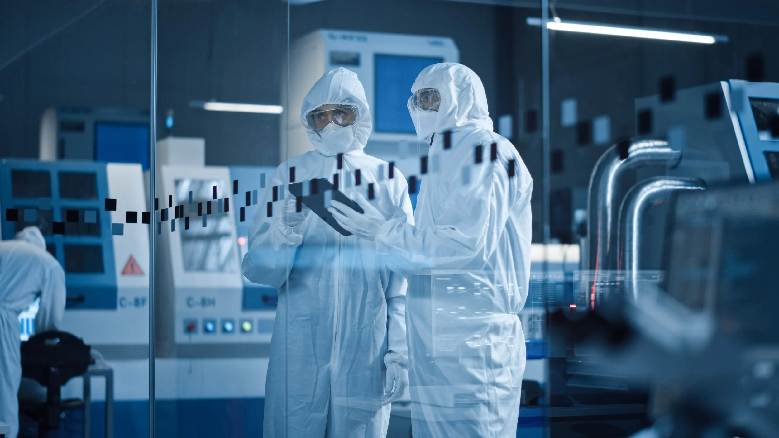 Two Sun Nutraceuticals scientists in clean-room gowns reviewing production records at the Fort Lauderdale facility.