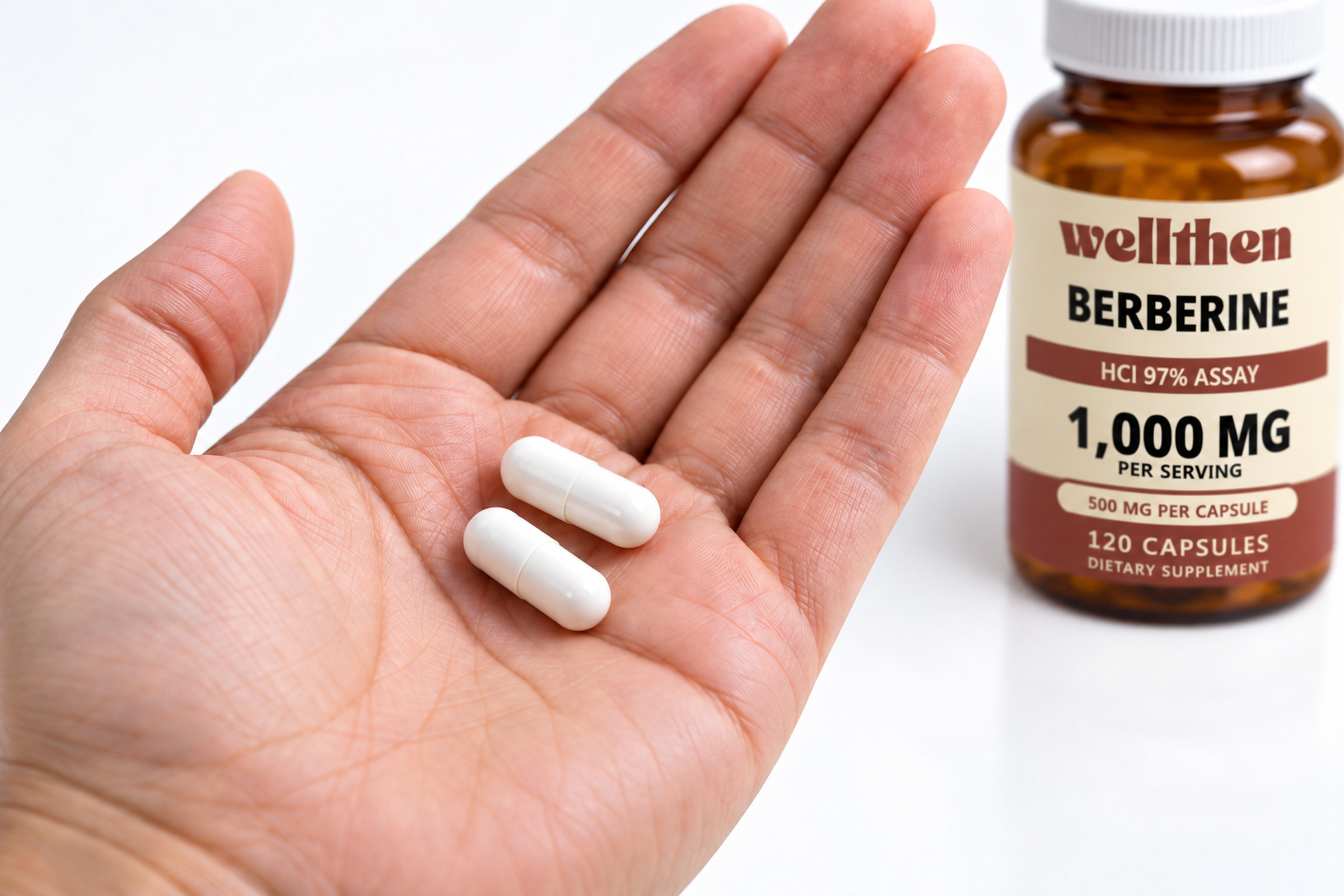 Two berberine capsules in a hand beside a finished 120-count bottle