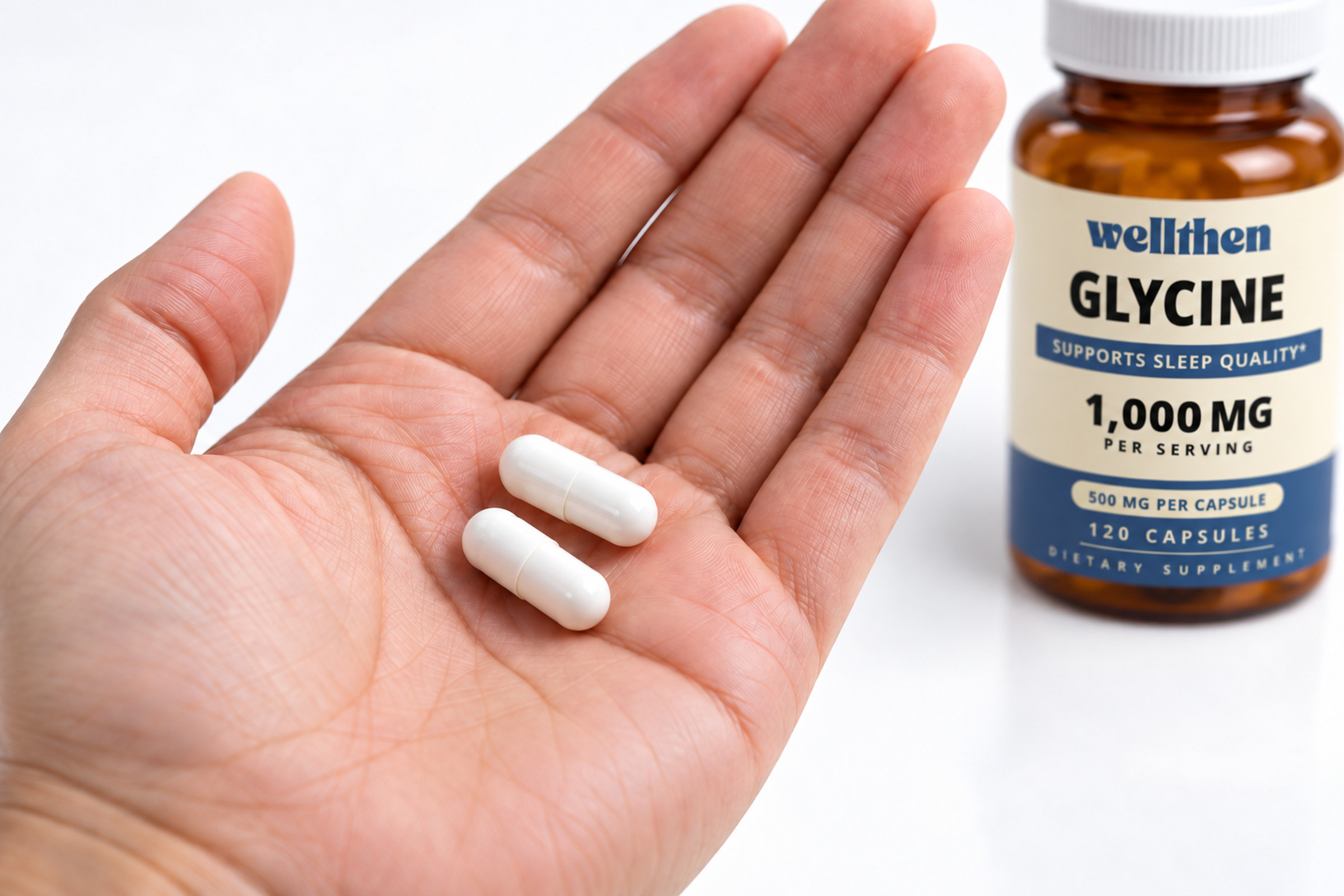 Two glycine capsules in a hand beside a finished 120-count bottle